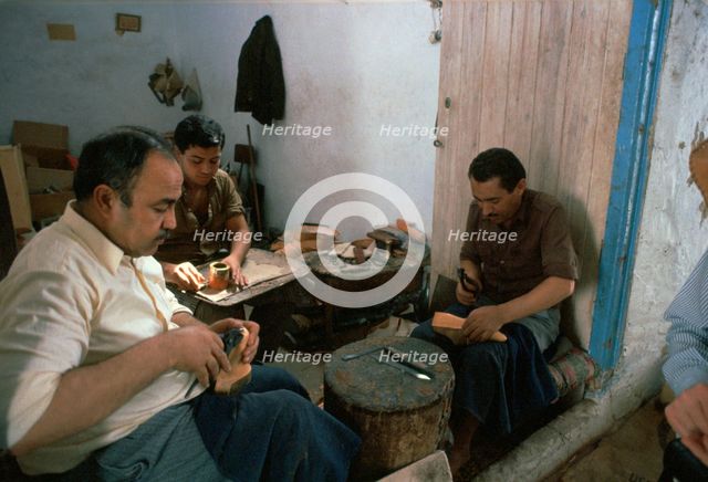 Shoemakers in a Tunisian souk. Artist: Unknown