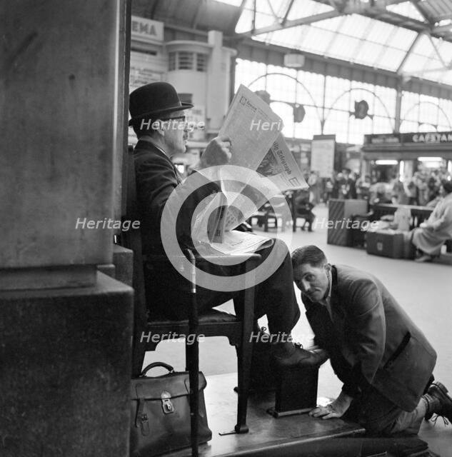 Shoeblack at Waterloo Station, London, 1962-1964. Artist: John Gay