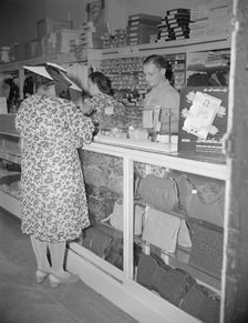 Shopper in a store at 7th Street and Florida Avenue, N.W., Washington, D.C., 1942. Creator: Gordon Parks