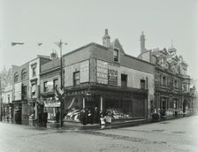 Shops and sign to Putney Roller Skating Rink, Putney Bridge Road, London, 1911