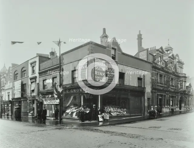 Shops and sign to Putney Roller Skating Rink, Putney Bridge Road, London, 1911. Artist: Unknown.