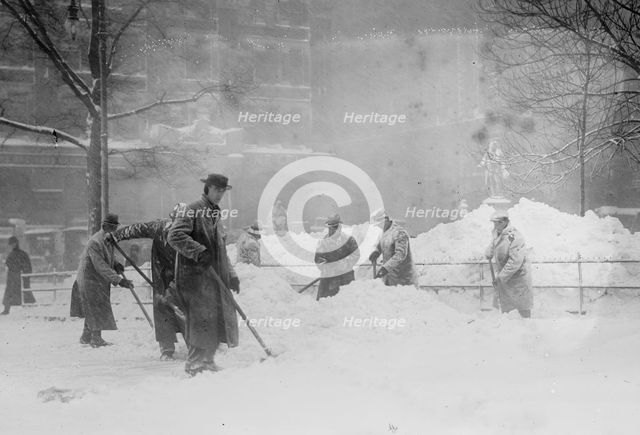 Shovelling snow in City Hall Park, New York, 1910. Creator: Bain News Service.