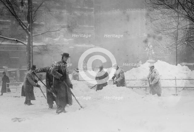 Shovelling snow in City Hall Park, New York, 1910. Creator: Bain News Service.