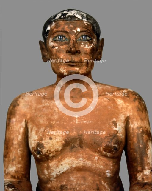 Sitting scribe in polychromed limestone, height 53 cm. belonging to the 5th Dynasty.