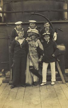 Six sailors, one in drag, pose for a group portrait on the deck of HMS St...(between 1910 and 1919?) Creator: Unknown