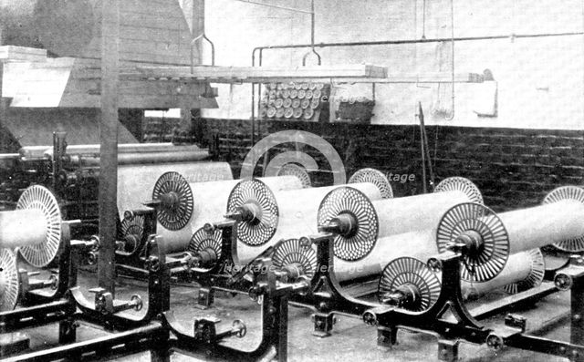 Sizing, which prepares and strengthens the yarns for the process of weaving, 1909.  Creator: Unknown.