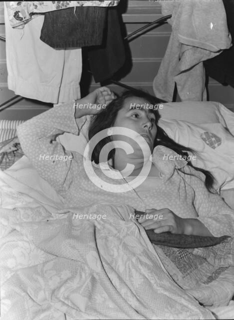 Sick woman in FSA camp for migratory agricultural workers, Tulare County, California, 1939. Creator: Dorothea Lange.