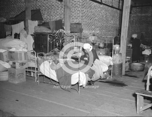 Sick flood refugee in the Red Cross temporary infirmary at Forrest City, Arkansas, 1937. Creator: Walker Evans.