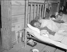 Sick flood refugee in the Red Cross temporary infirmary at Forrest City, Arkansas, 1937. Creator: Walker Evans