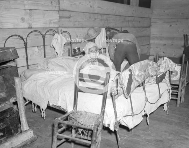 Sick Negro in the Red Cross temporary infirmary for flood refugees, Forrest City, Arkansas, 1937. Creator: Walker Evans.