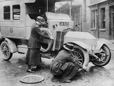 Siddeley Deasy ambulance 1911, women changing wheel. Creator: Unknown