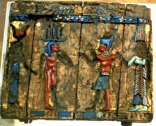 Side of a wooden box with deified human figures in polychromed stone