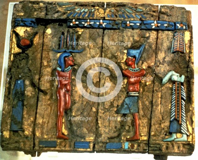 Side of a wooden box with deified human figures in polychromed stone.
