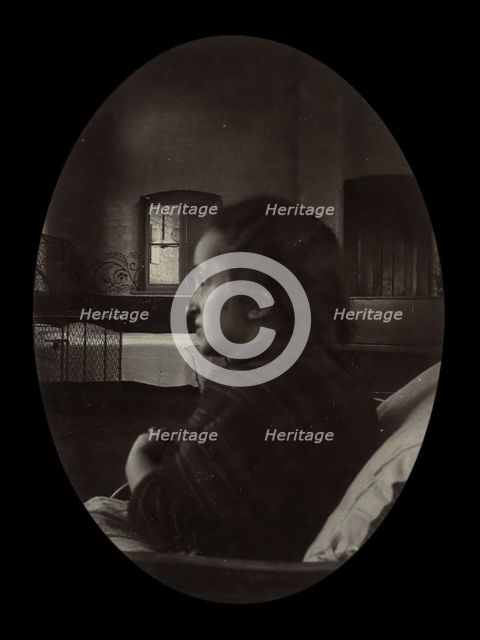Side profile of a young woman with a misshapen head, wrapped in a tartan shawl, probably... Creator: Unknown.
