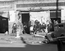 Sidewalk scene in Selma, Alabama, 1935. Creator: Walker Evans