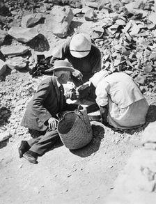 Sifting the dust from the floor of the Tomb of Tutankhamun, Valley of the Kings, Egypt, 1922. Creator: Harry Burton