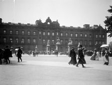 Sightseers crowd around the gates of Buckingham Palace, London