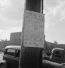 Sign tacked to pole near the post office, Main street, Pittsboro, North Carolina, 1939. Creator: Dorothea Lange