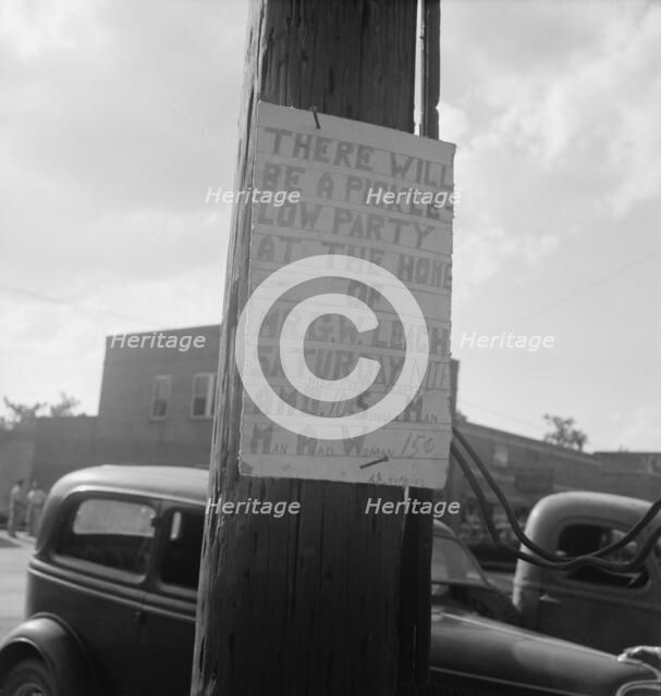 Sign tacked to pole near the post office, Main street, Pittsboro, North Carolina, 1939. Creator: Dorothea Lange.