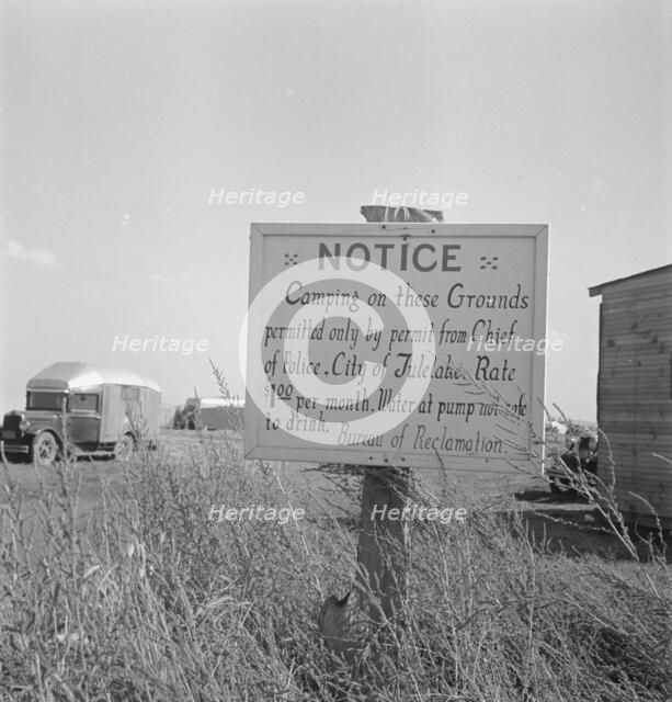 Sign on camp site opposite potato packing sheds, Tulelake, Siskiyou County, California, 1939. Creator: Dorothea Lange.