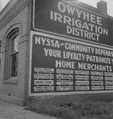 Sign on old bank building which now houses office of Bureau..., Nyssa, Malheur County, Oregon, 1939. Creator: Dorothea Lange