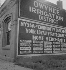 Sign on old bank building which now houses office of Bureau..., Nyssa, Malheur County, Oregon, 1939. Creator: Dorothea Lange