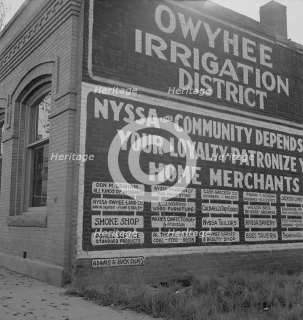Sign on old bank building which now houses office of Bureau..., Nyssa, Malheur County, Oregon, 1939. Creator: Dorothea Lange.