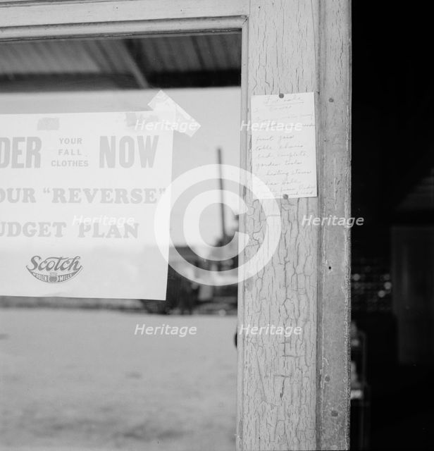 Sign on post office door: Farm animals and household equipment..., Vader, western Washington, 1939. Creator: Dorothea Lange.