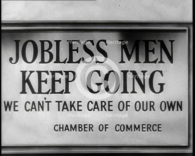 Sign reads: 'Jobless Men Keep Going - We Can Take Care of Our Own - Chamber of Commerce', 1932. Creator: British Pathe Ltd.