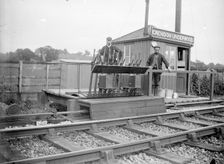 Signalmen pose outside a signal box near Grendon Underwood, Northamptonshire, c1872-c1923. Artist: Alfred Newton & Sons