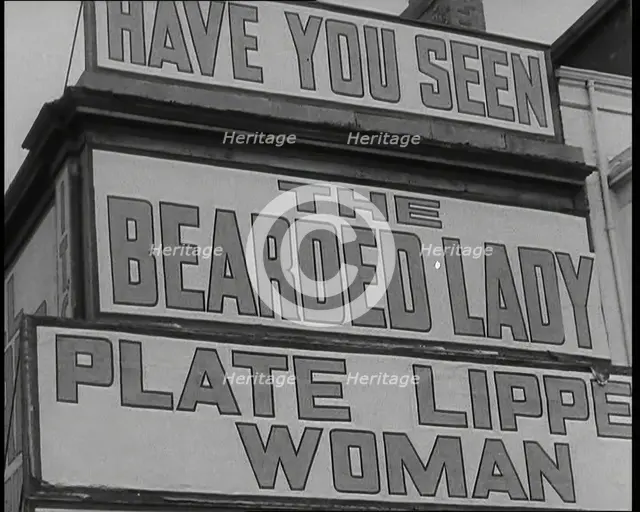 Signs at a Seaside Show 'HAVE YOU SEEN' 'THE BEARDED LADY' 'PLATE LIPPED WOMAN', 1938. Creator: British Pathe Ltd.