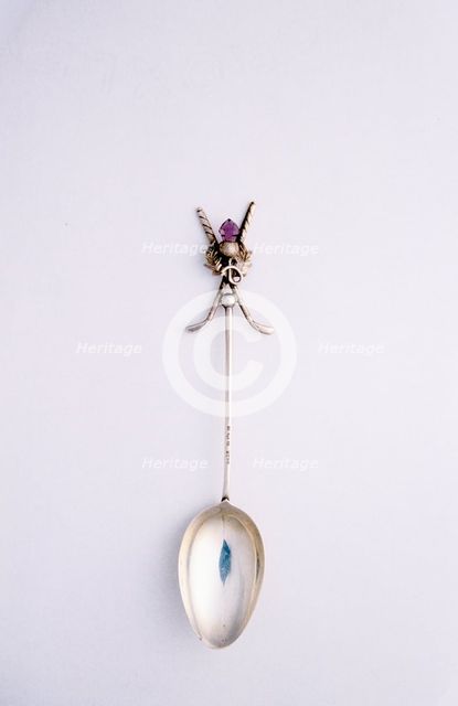 Silver spoon with crossed golf club motif, British, c1920s.  Creator: Unknown.