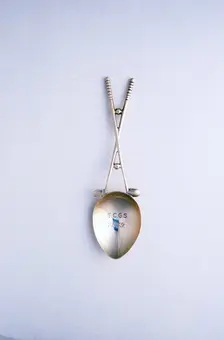Silver spoon with crossed golf clubs motif, c1910-c1920. Creator: Unknown
