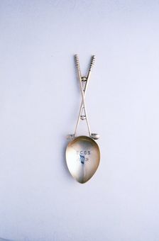 Silver spoon with crossed golf clubs motif, c1910-c1920. Creator: Unknown