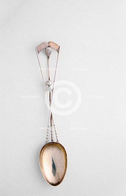 Silver spoon with crossed golf clubs and ball, c1920s. Creator: Unknown.