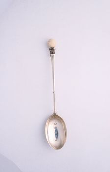 Silver spoon with golf ball motif, c1910. Creator: Unknown