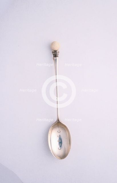 Silver spoon with golf ball motif, c1910. Creator: Unknown.