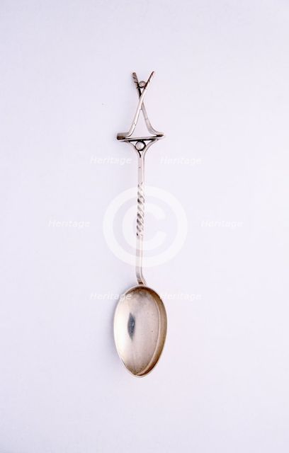Silver spoon with two crossed clubs and ball, British, 1922. Creator: Unknown.