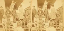Simplicity, Alabama, U.S.A. [Group gathered on a porch, in town], (1868-1900?). Creator: Benjamin West Kilburn
