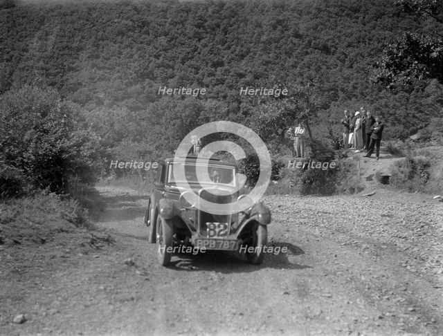 Singer 9 sports saloon competing in the Mid Surrey AC Barnstaple Trial, Beggars Roost, Devon, 1934. Artist: Bill Brunell.