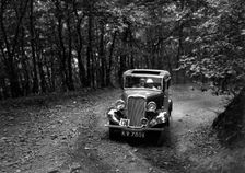 Singer Nine saloon competing in the B&HMC Brighton-Beer Trial, Fingle Bridge Hill, Devon, 1934. Artist: Bill Brunell
