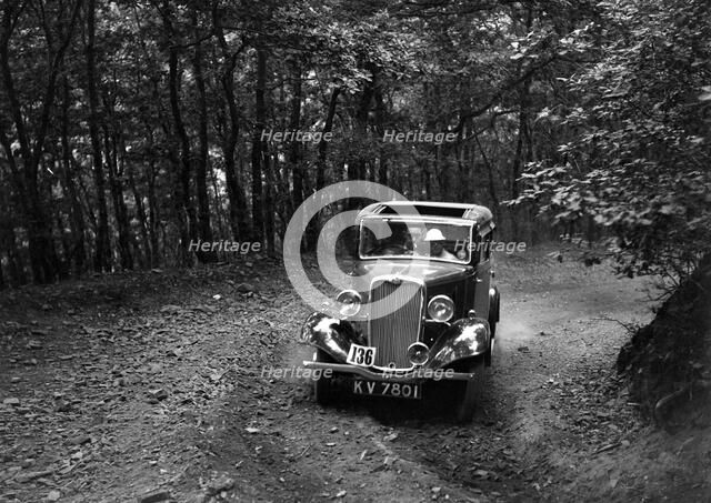 Singer Nine saloon competing in the B&HMC Brighton-Beer Trial, Fingle Bridge Hill, Devon, 1934. Artist: Bill Brunell.