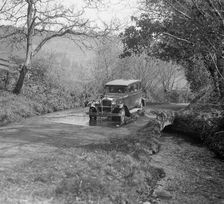 Singer Super Six driving through a ford at Croydon Hill, near Timberscombe, Somerset, 1930s Artist: Bill Brunell