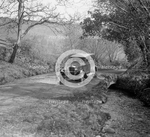 Singer Super Six driving through a ford at Croydon Hill, near Timberscombe, Somerset, 1930s Artist: Bill Brunell.