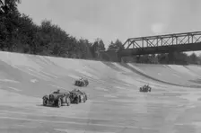Singers of TW Fassett and Alf Langley and an MG racing at a MCC meeting, Brooklands, Surrey, 1933. Artist: Bill Brunell