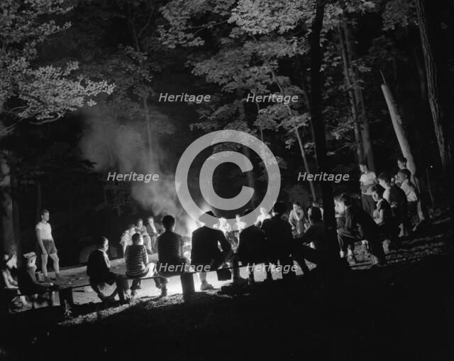 Singing around the camp fire at Camp Nathan Hale, Southfields, New York, 1943 Creator: Gordon Parks.