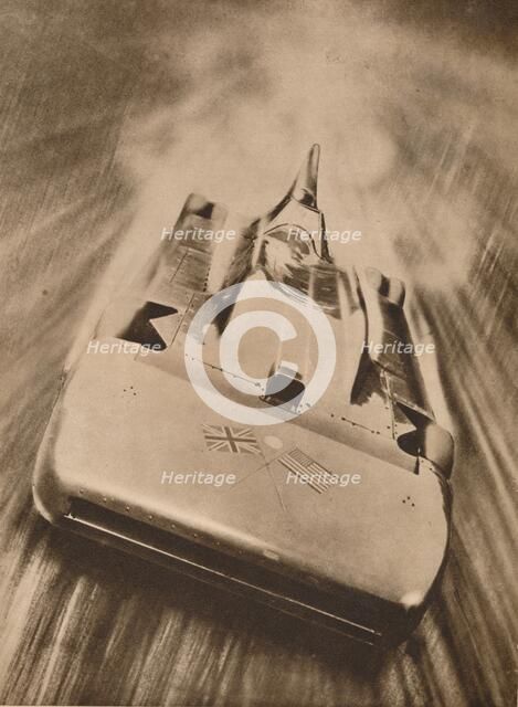 Sir Malcolm Campbell at high speed in `Blue Bird`, 1935. Artist: Unknown.