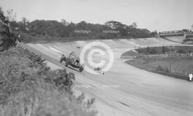 Sir Henry Birkin's Bentley leading Earl Howe's Bugatti Type 54, BARC meeting, Brooklands, May 1932. Artist: Bill Brunell.