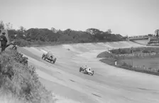 Sir Henry Birkin's Bentley racing RJ Munday's Vauxhall 30/98, BARC meeting, Brooklands, 16 May 1932. Artist: Bill Brunell