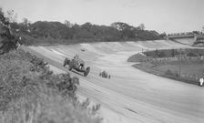 Sir Henry Birkin's Bentley leading Earl Howe's Bugatti Type 54, BARC meeting, Brooklands, May 1932. Artist: Bill Brunell